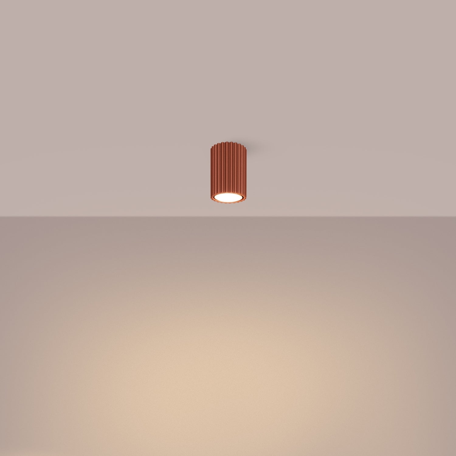 Red Ochre Ribbed Surface Spotlight switched on in modern UK home interior, warm LED glow