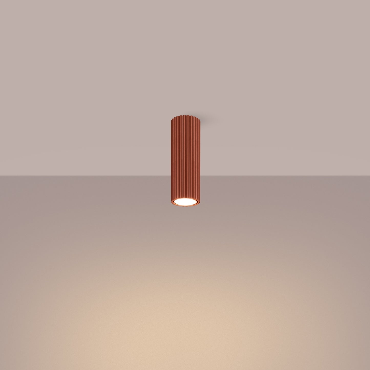 Red Ochre Ribbed Tube Ceiling Spotlight 20cm switched on in modern UK home interior, warm LED glow