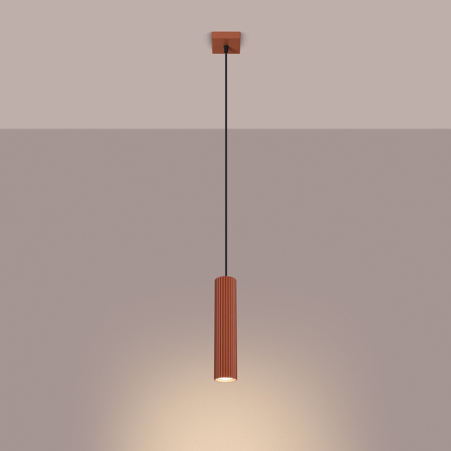 Red Ochre Ribbed Cylinder Pendant Light switched on in modern UK home interior, warm LED glow