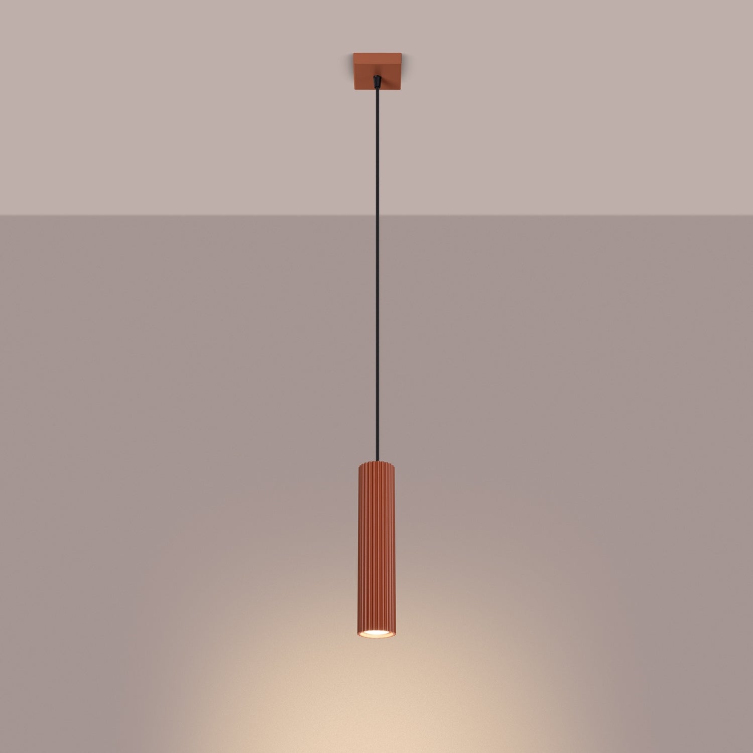 Red Ochre Ribbed Cylinder Pendant Light switched on in modern UK home interior, warm LED glow