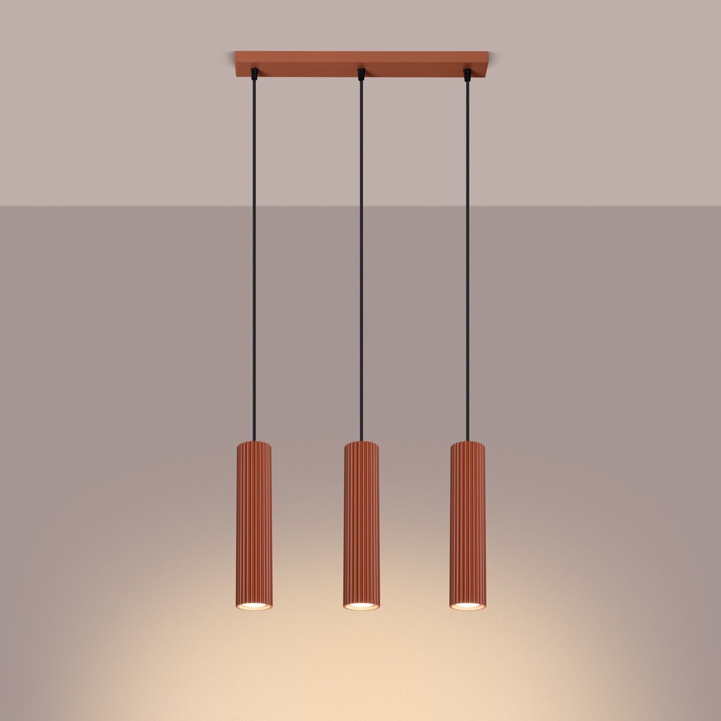 Red Ochre Triple Ribbed Pendant Bar switched on in modern UK home interior, warm LED glow