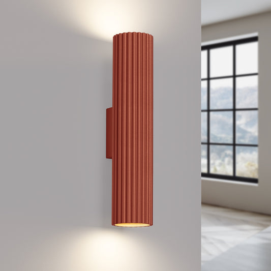 Red Ochre Twin Ribbed Wall Light Up Down switched on in modern UK home interior, warm LED glow