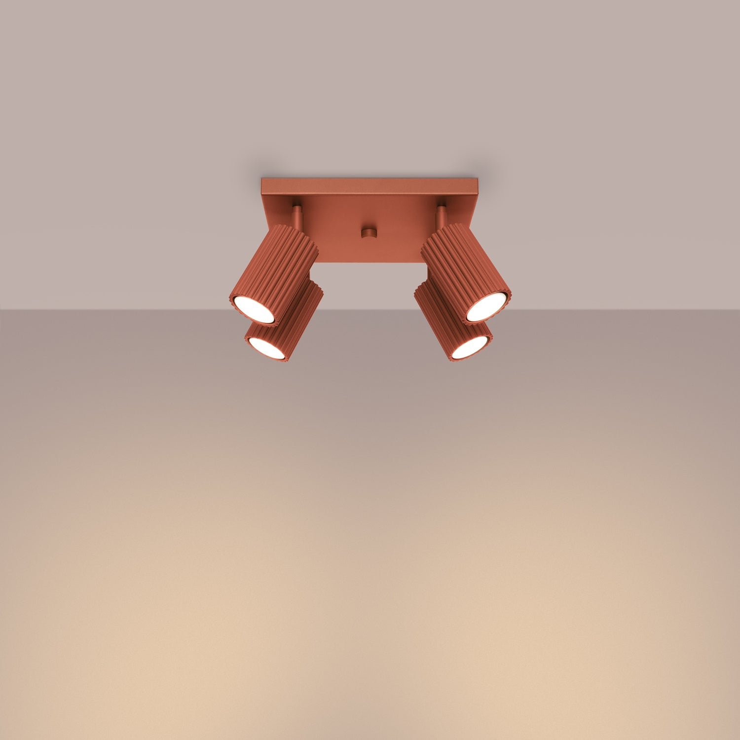 Red Ochre Quad Ribbed Spotlight Cluster switched on in modern UK home interior, warm LED glow