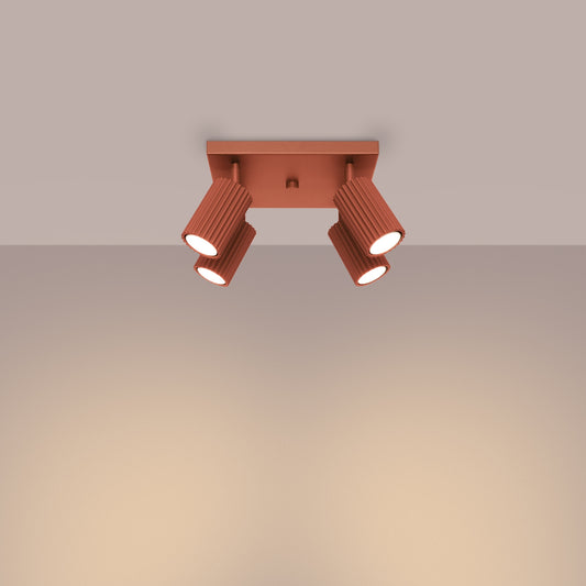 Red Ochre Quad Ribbed Spotlight Cluster switched on in modern UK home interior, warm LED glow