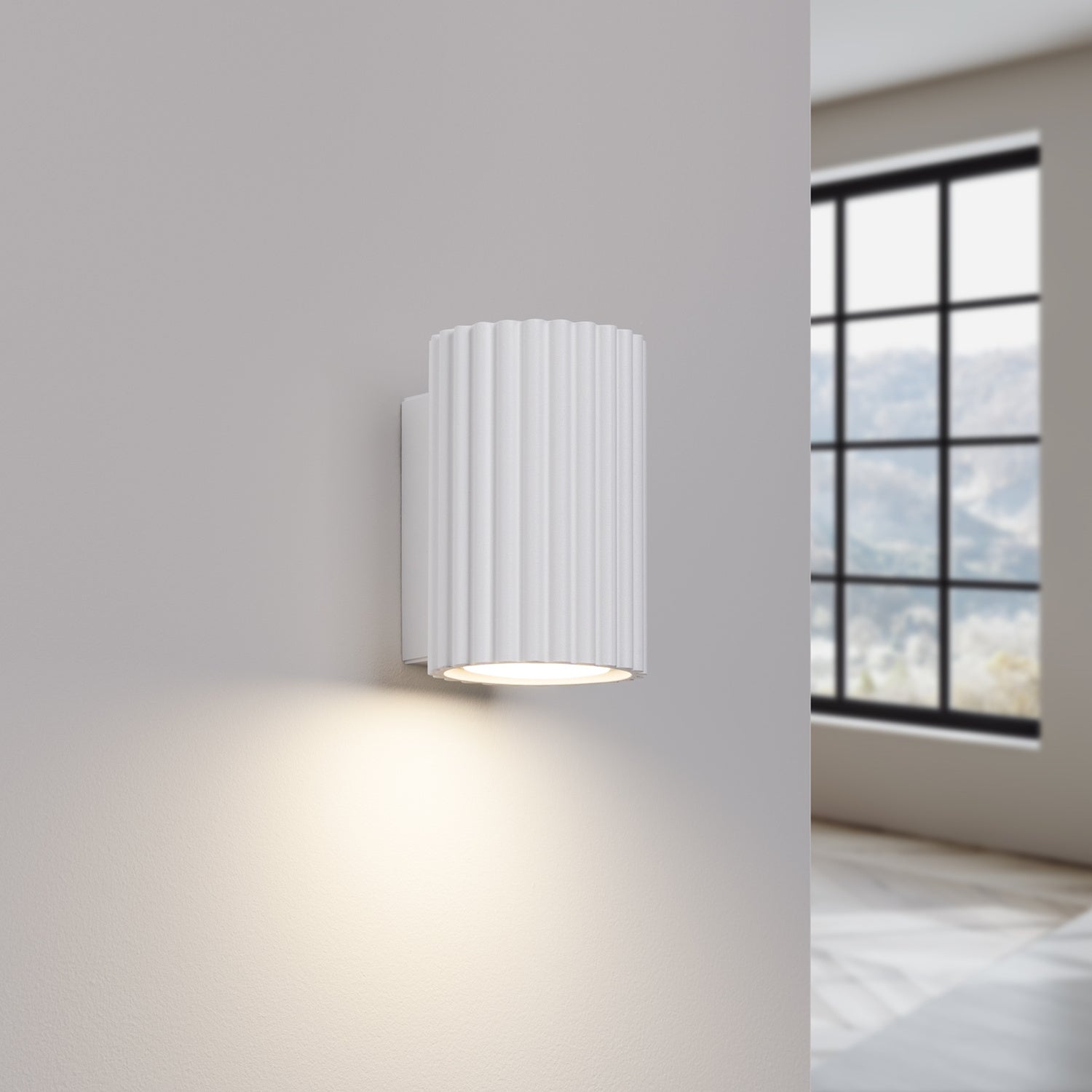 White Mini Ribbed Cylinder Wall Light switched on in modern UK home interior, warm LED glow