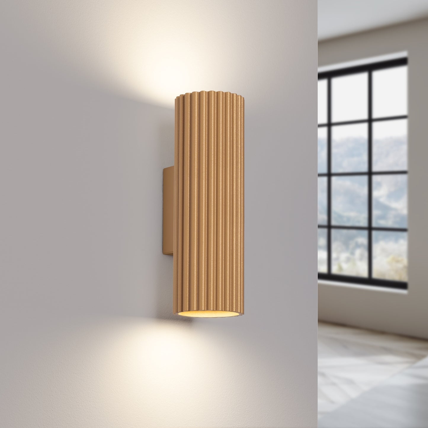 Gold Ribbed Up Down Wall Light switched on in modern UK home interior, warm LED glow
