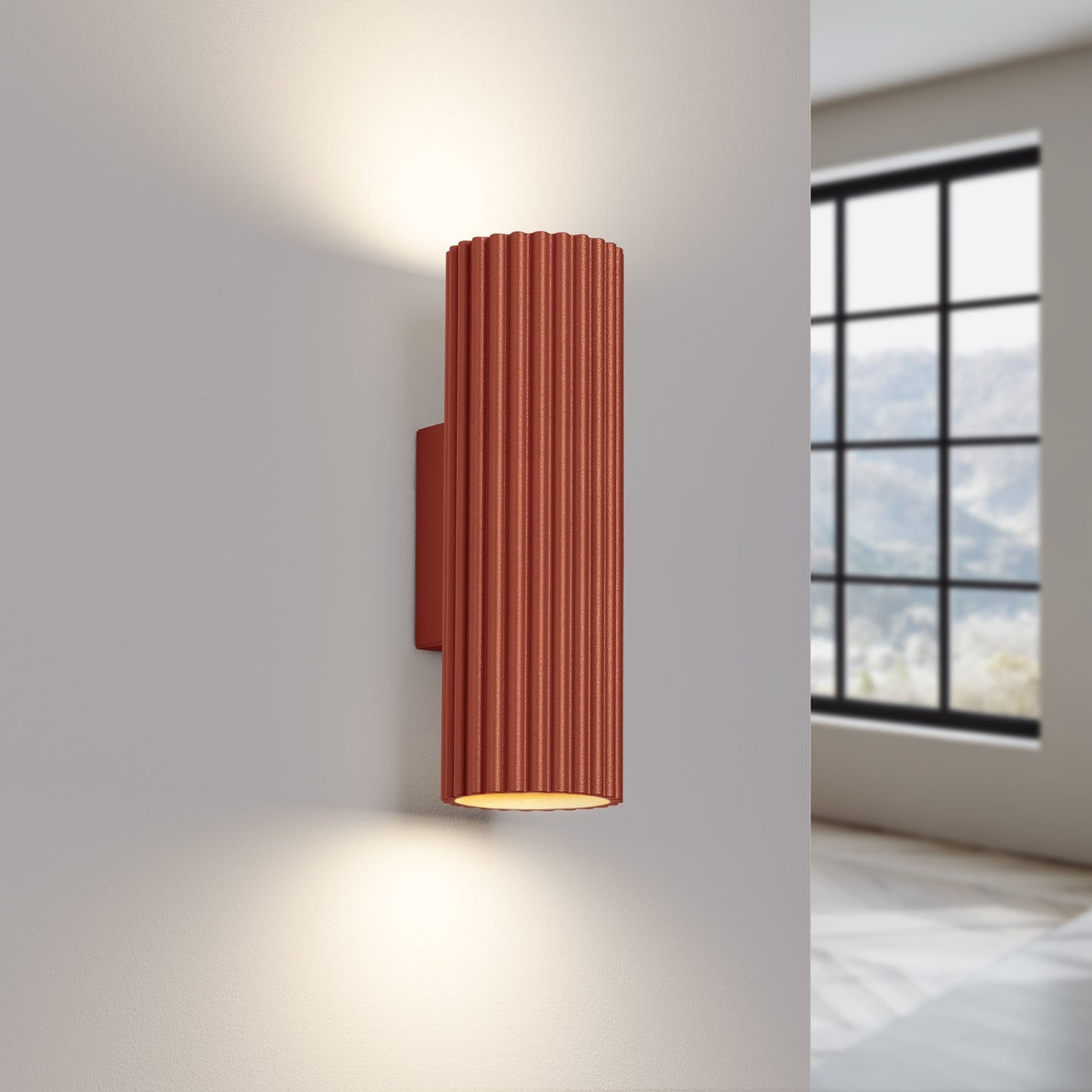 Red Ochre Ribbed Up Down Wall Light switched on in modern UK home interior, warm LED glow
