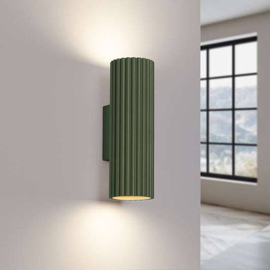 Olive Green Ribbed Up Down Wall Light switched on in modern UK home interior, warm LED glow
