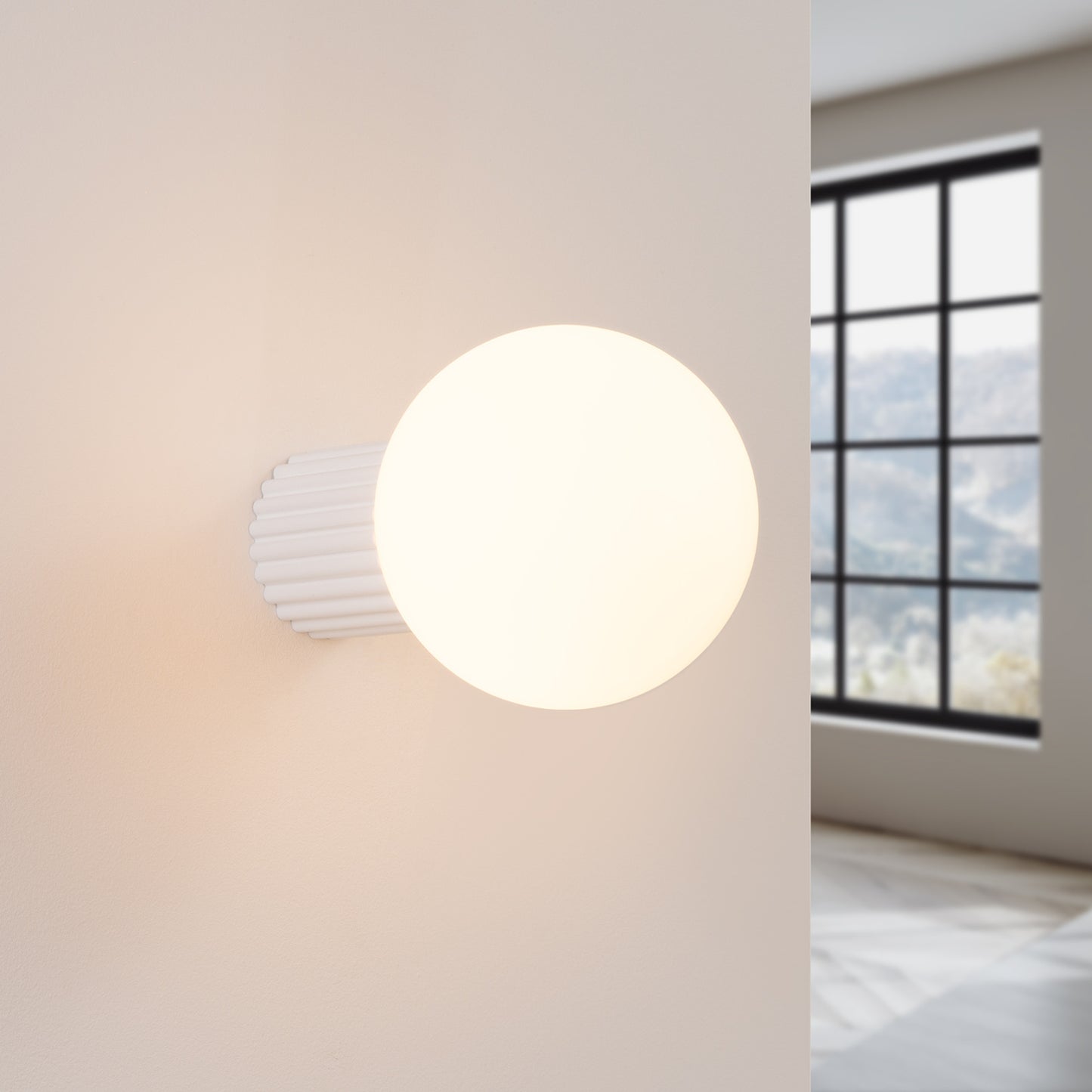 White Opal Glass Globe Wall Light IP44 switched on in modern UK home interior, warm LED glow