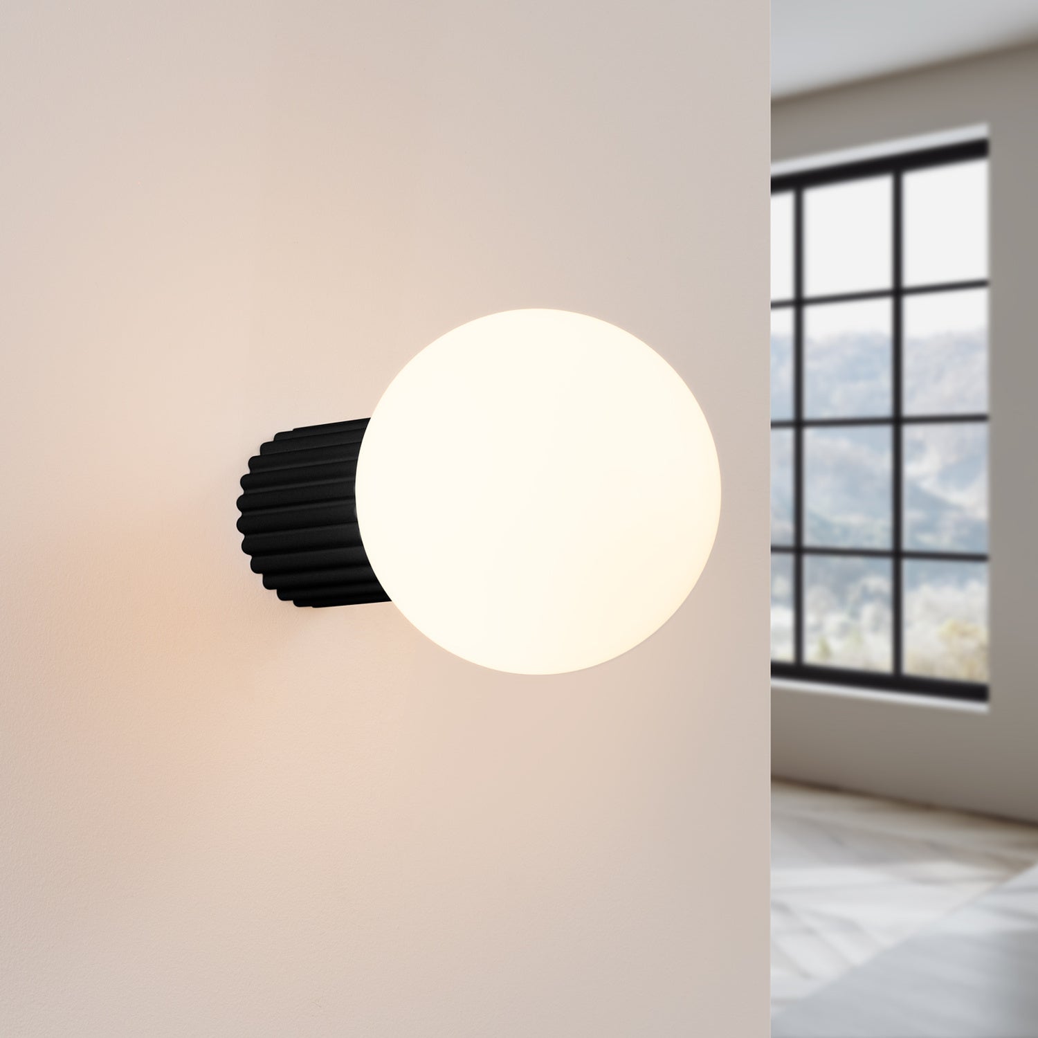 Black Opal Glass Globe Wall Light IP44 switched on in modern UK home interior, warm LED glow