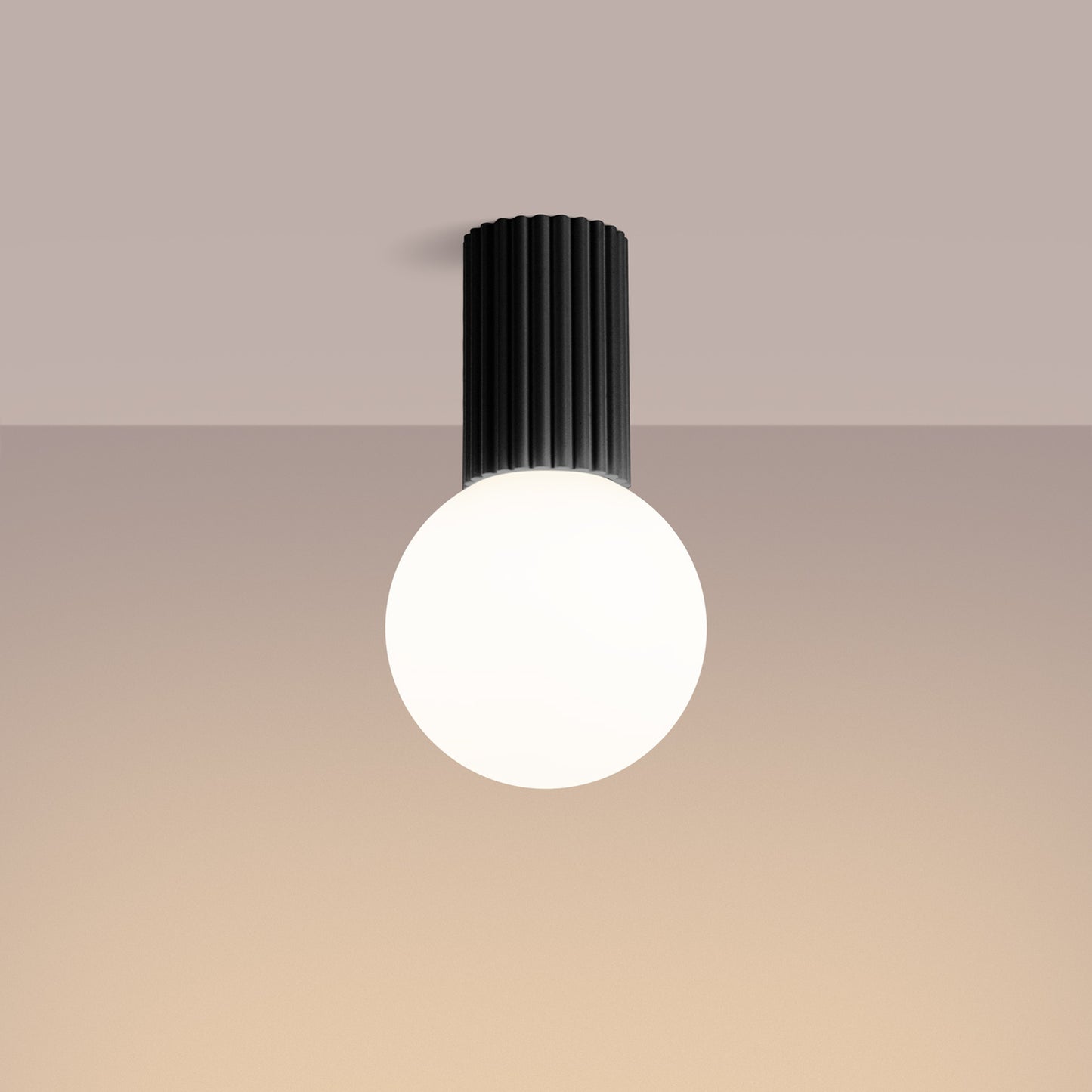 Black Opal Glass Globe Ceiling Light IP44 switched on in modern UK home interior, warm LED glow