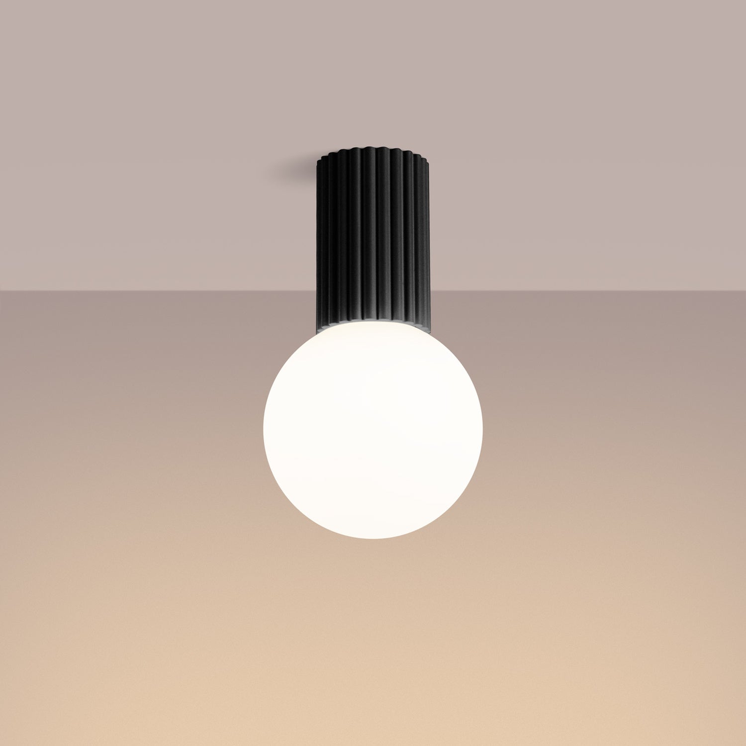 Black Opal Glass Globe Ceiling Light IP44 switched on in modern UK home interior, warm LED glow