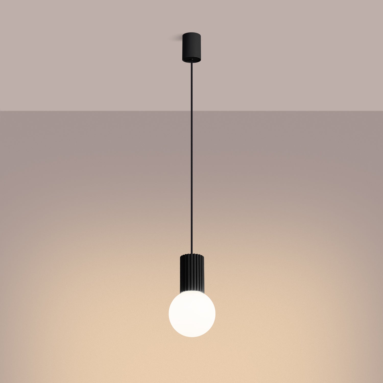 Black Opal Glass Globe Pendant Light switched on in modern UK home interior, warm LED glow