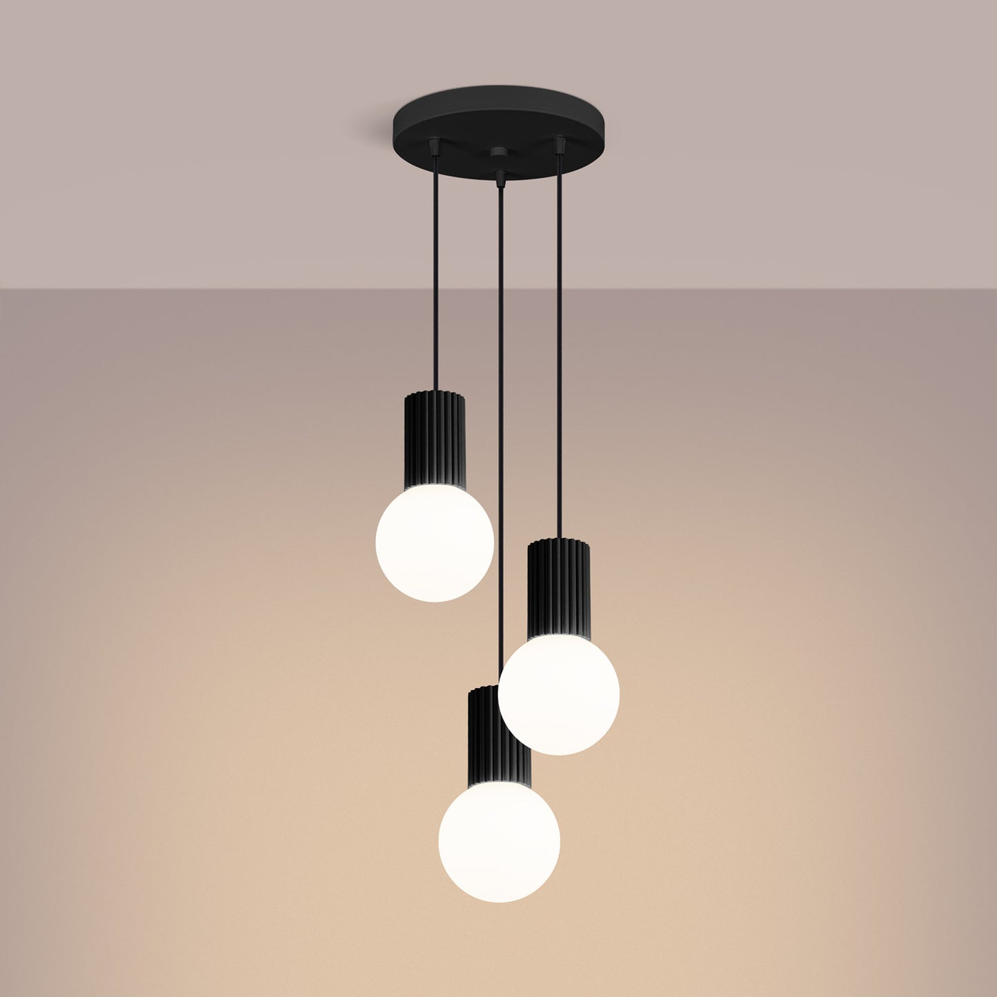 Black Triple Glass Globe Pendant Cluster switched on in modern UK home interior, warm LED glow