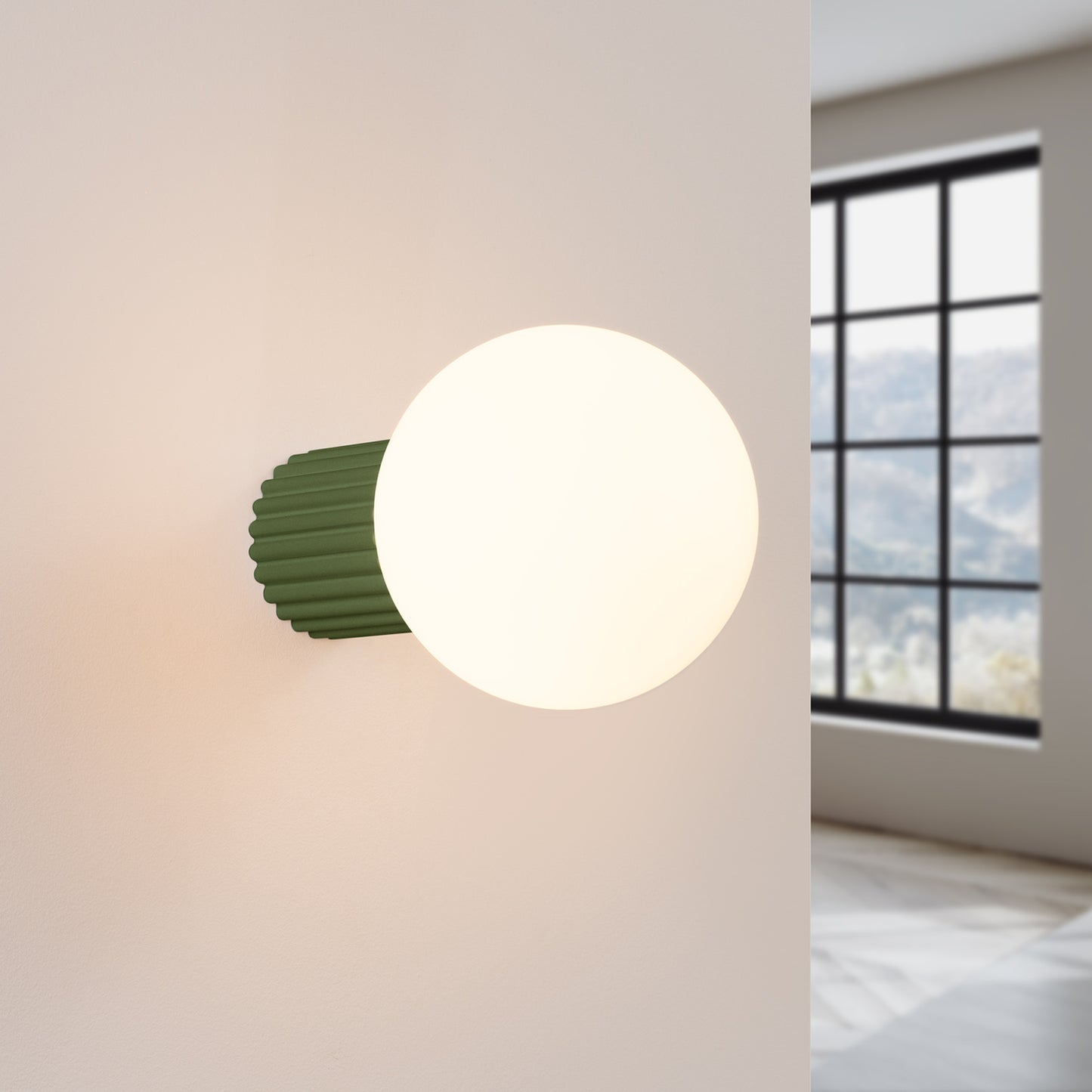 Olive Green Opal Glass Globe Wall Light IP44 switched on in modern UK home interior, warm LED glow