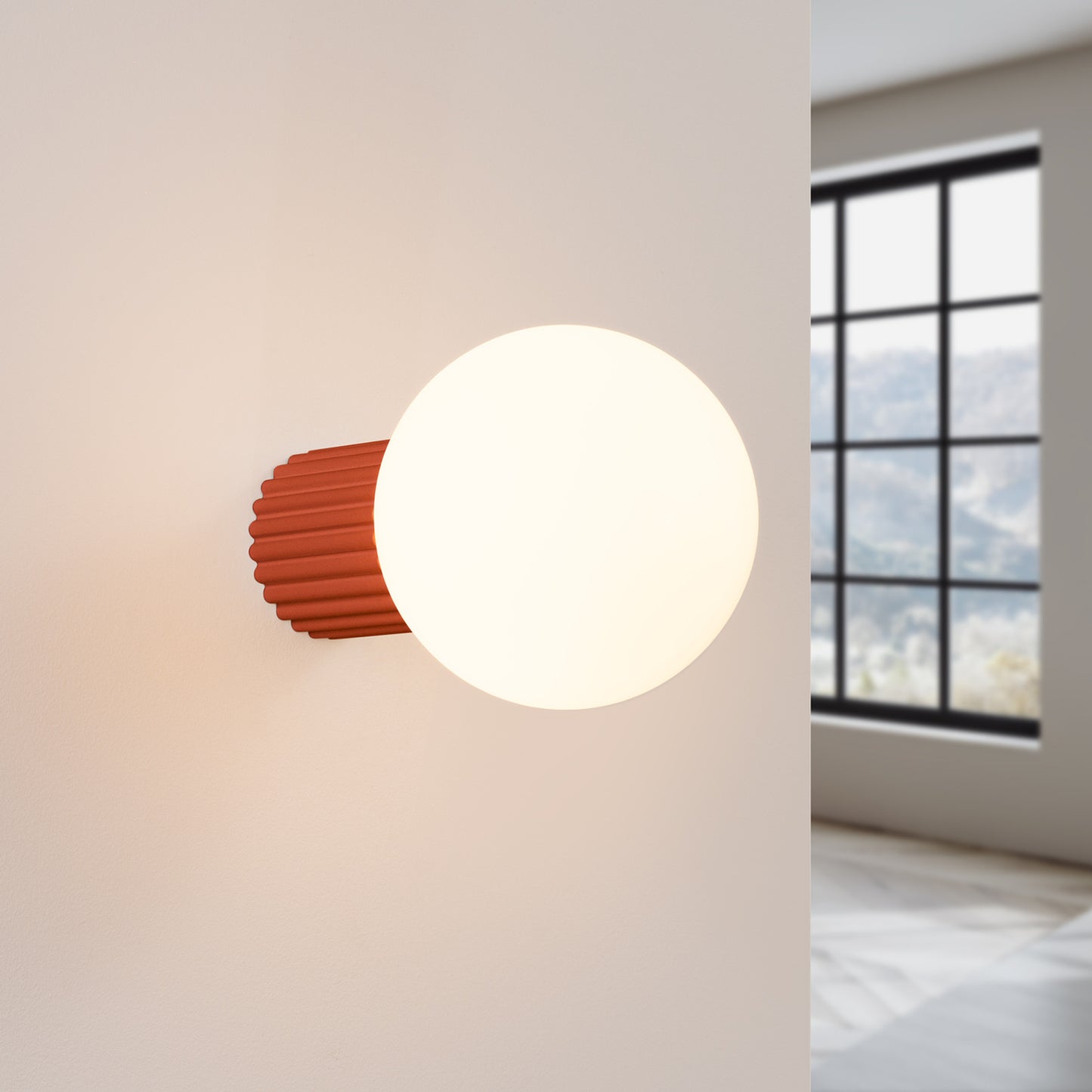 Red Ochre Opal Glass Globe Wall Light IP44 switched on in modern UK home interior, warm LED glow