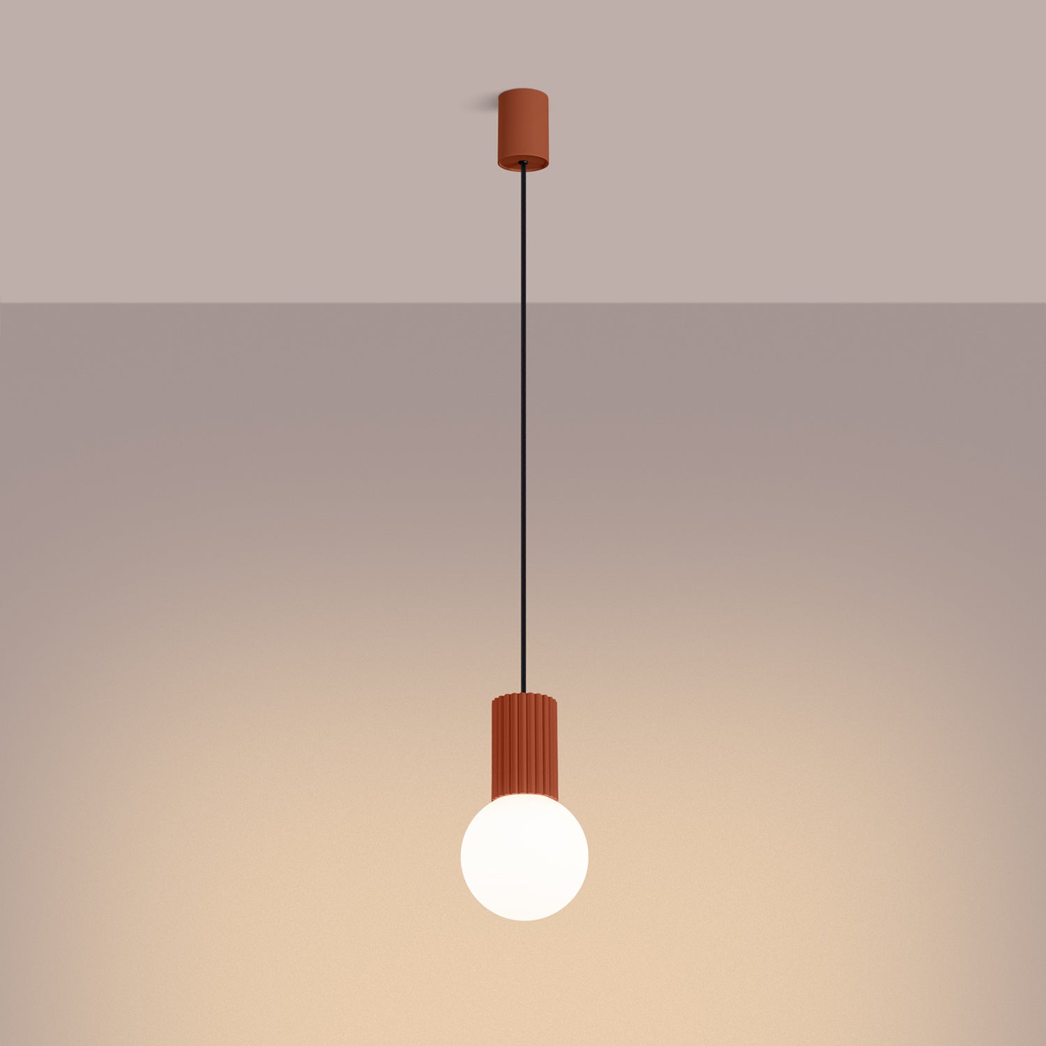 Red Ochre Opal Glass Globe Pendant Light switched on in modern UK home interior, warm LED glow