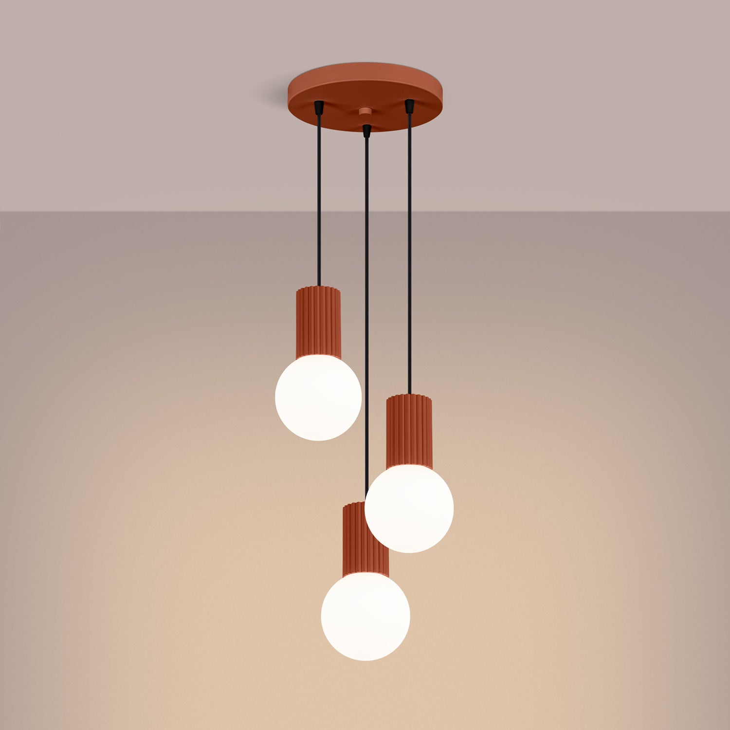 Red Ochre Triple Glass Globe Pendant Cluster switched on in modern UK home interior, warm LED glow