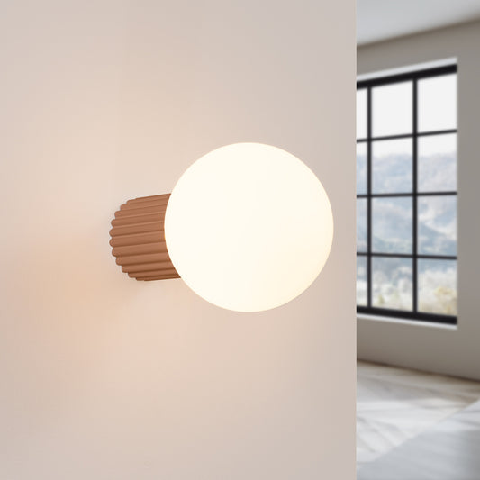 Mocha Opal Glass Globe Wall Light IP44 switched on in modern UK home interior, warm LED glow