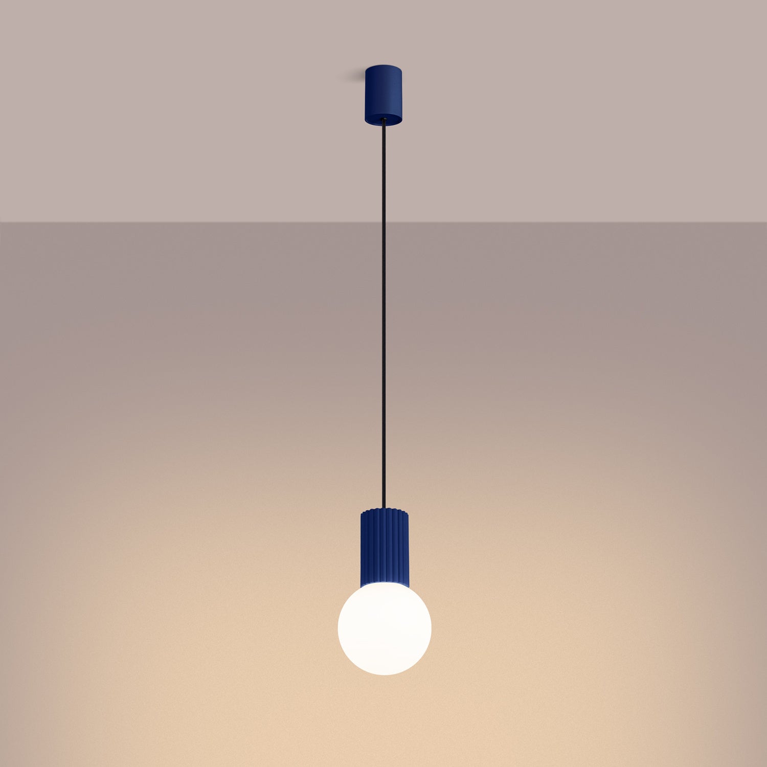 Ultramarine Opal Glass Globe Pendant Light switched on in modern UK home interior, warm LED glow