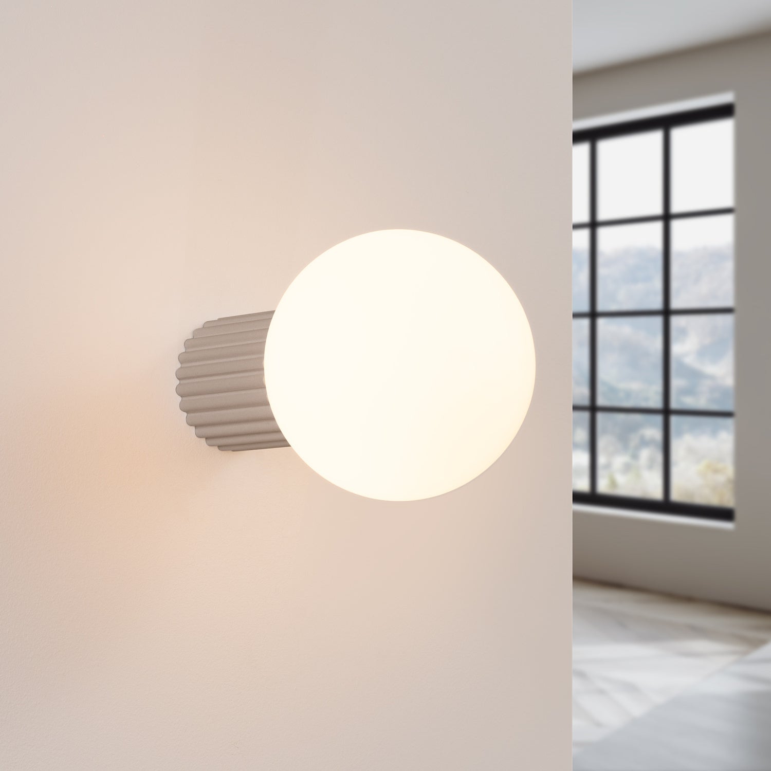 Taupe Opal Glass Globe Wall Light IP44 switched on in modern UK home interior, warm LED glow
