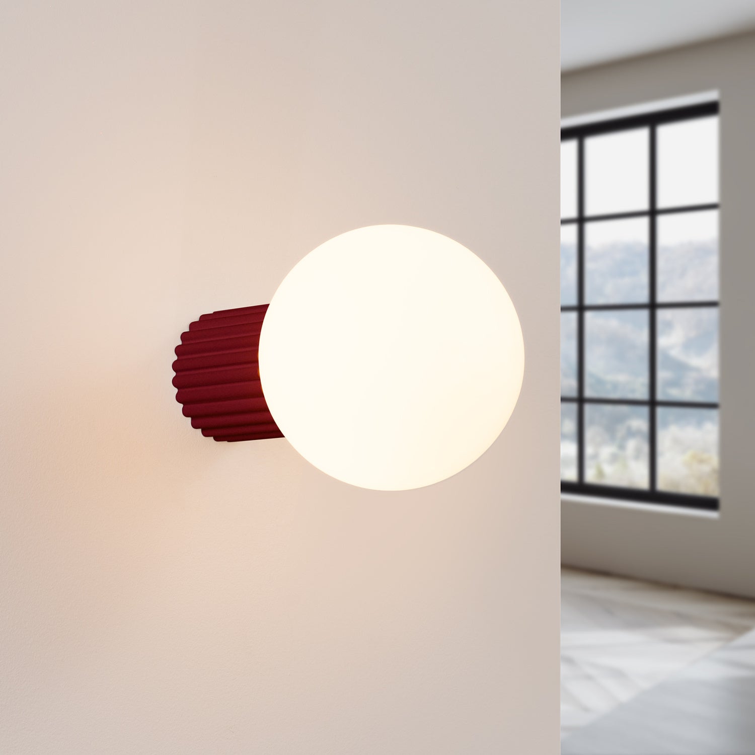 Burgundy Opal Glass Globe Wall Light IP44 switched on in modern UK home interior, warm LED glow