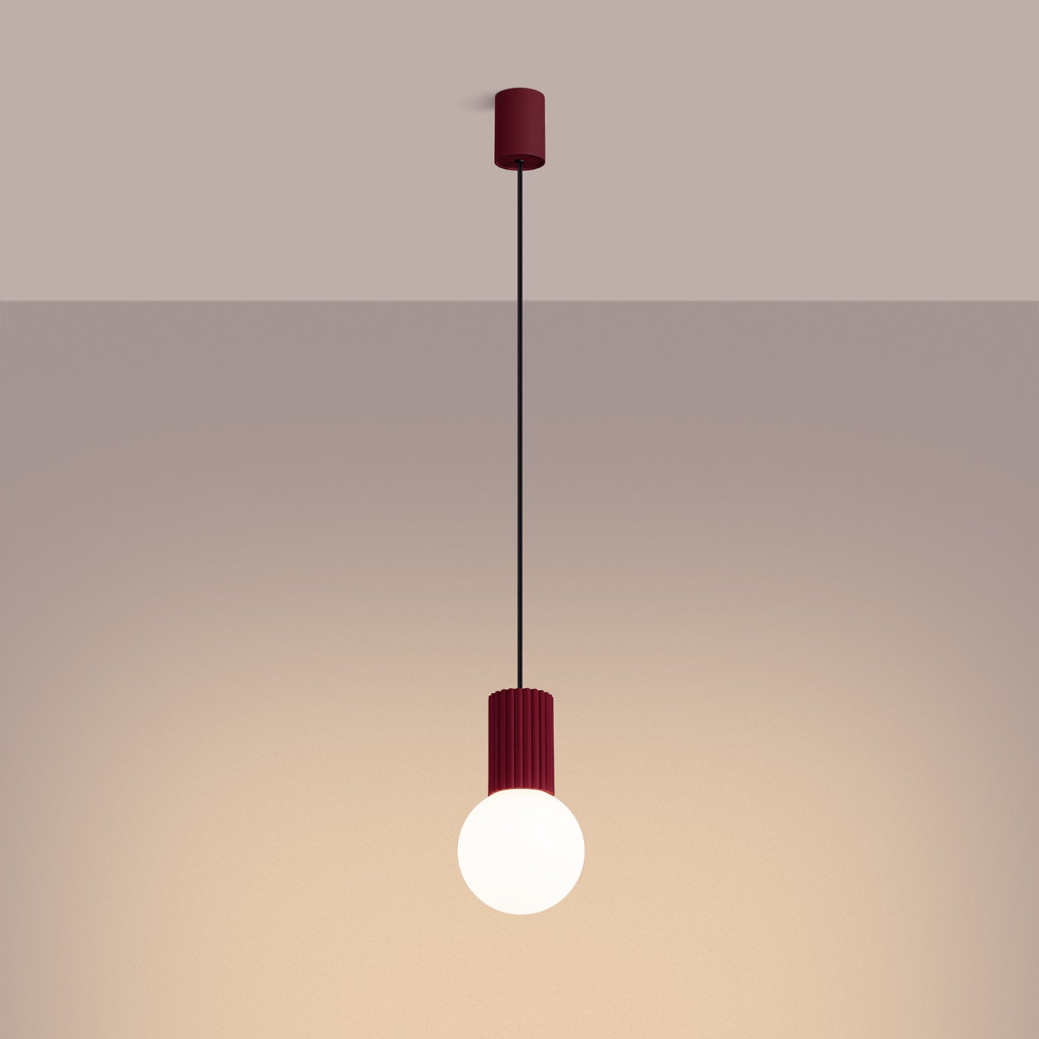 Burgundy Opal Glass Globe Pendant Light switched on in modern UK home interior, warm LED glow