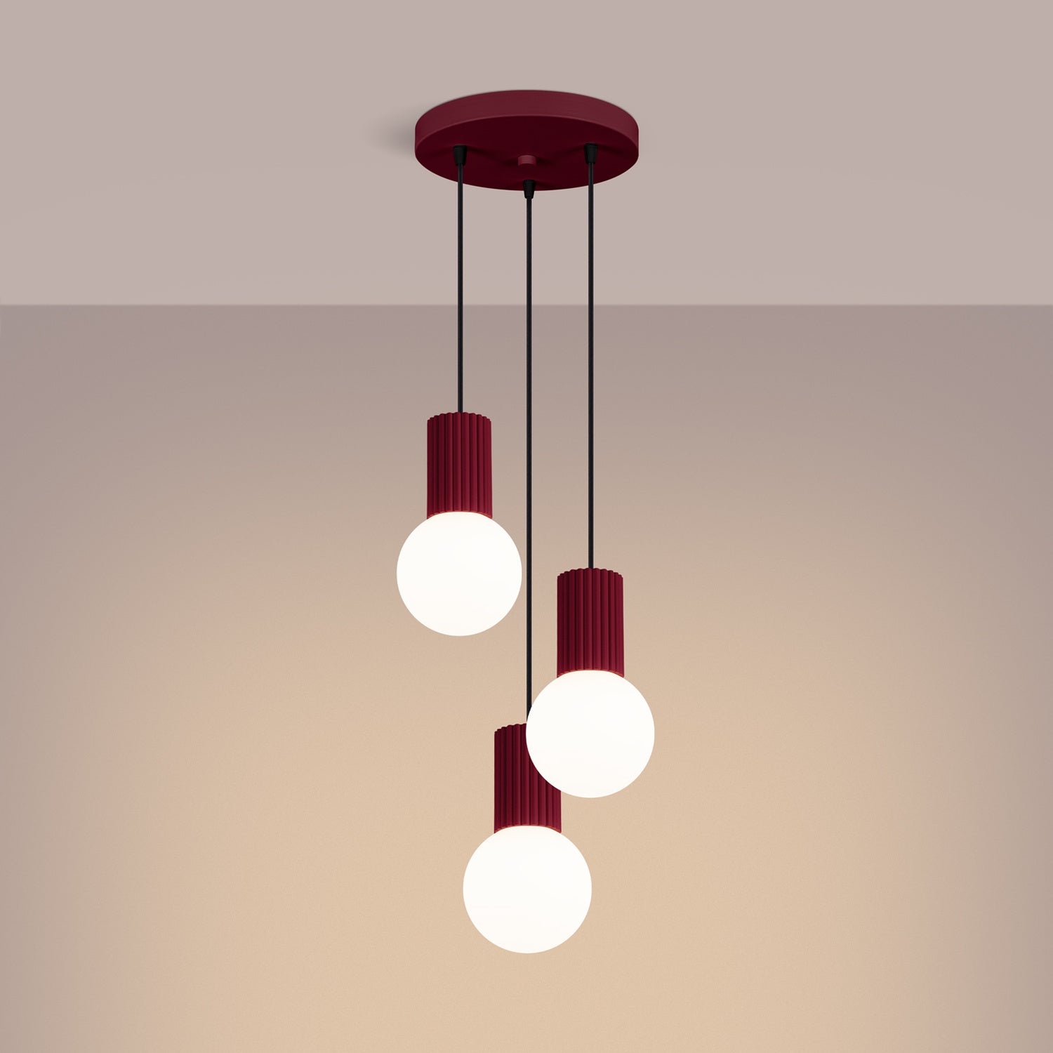 Burgundy Triple Glass Globe Pendant Cluster switched on in modern UK home interior, warm LED glow