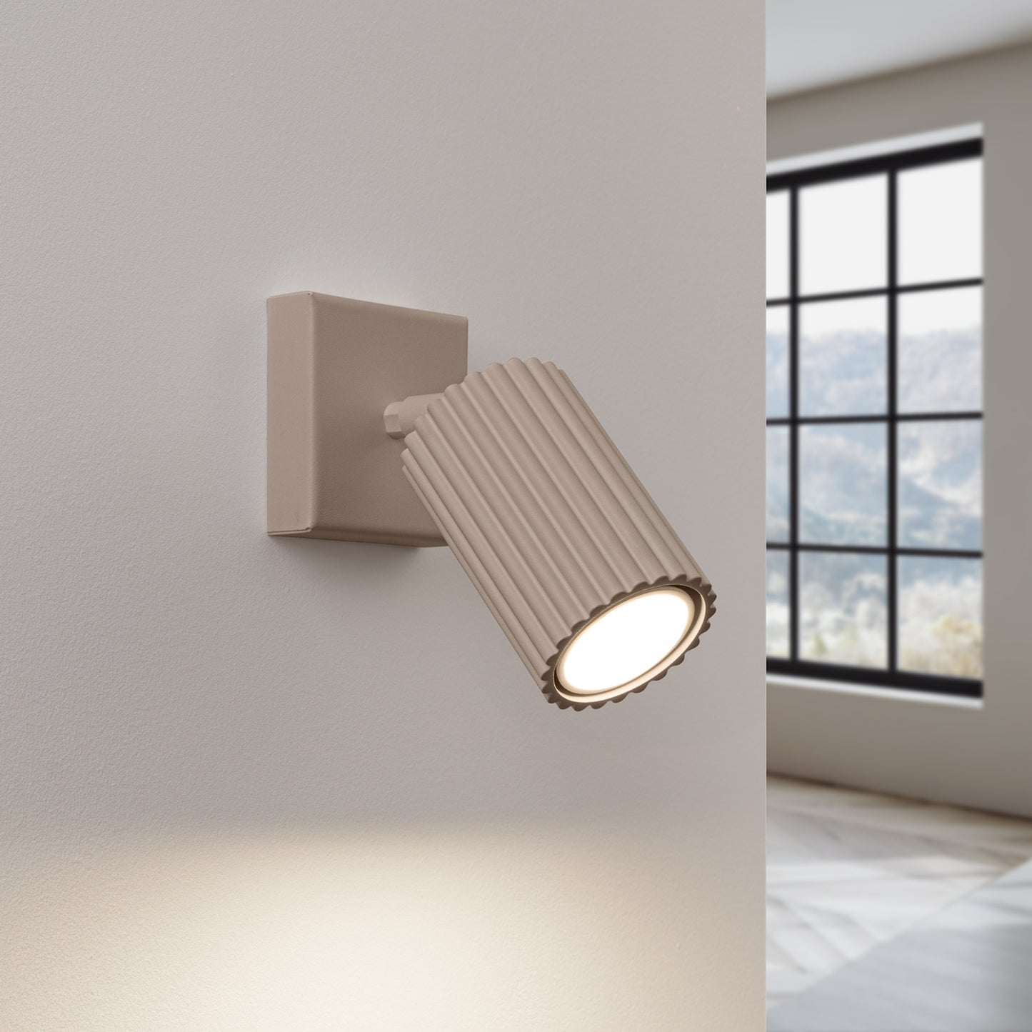 Taupe Ribbed Tube Wall Light switched on in modern UK home interior, warm LED glow
