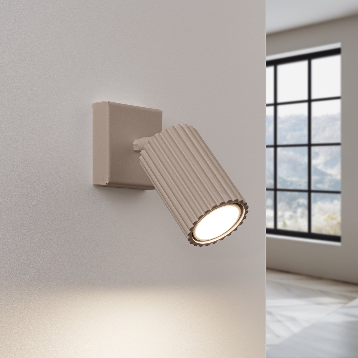 Taupe Ribbed Tube Wall Light switched on in modern UK home interior, warm LED glow