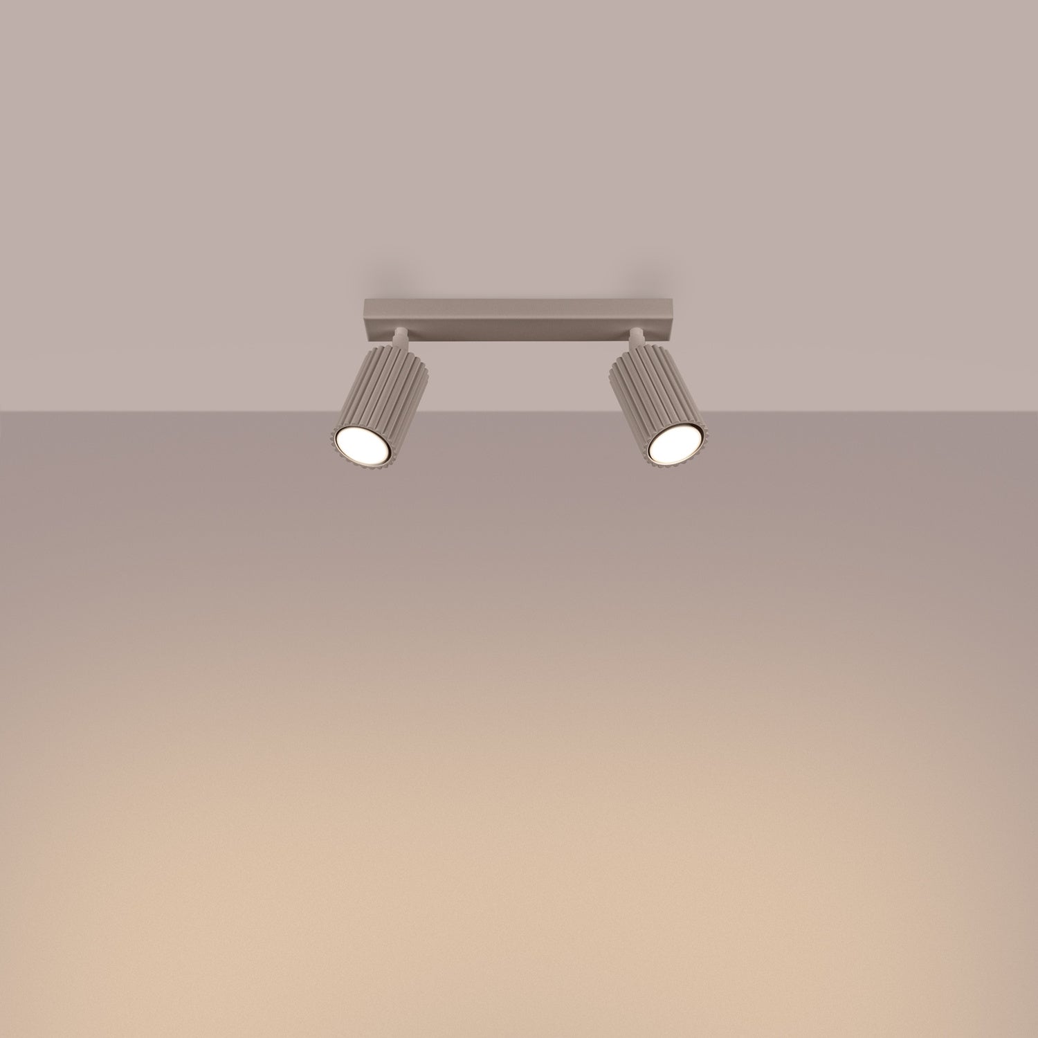 Taupe Twin Ribbed Surface Spotlight switched on in modern UK home interior, warm LED glow