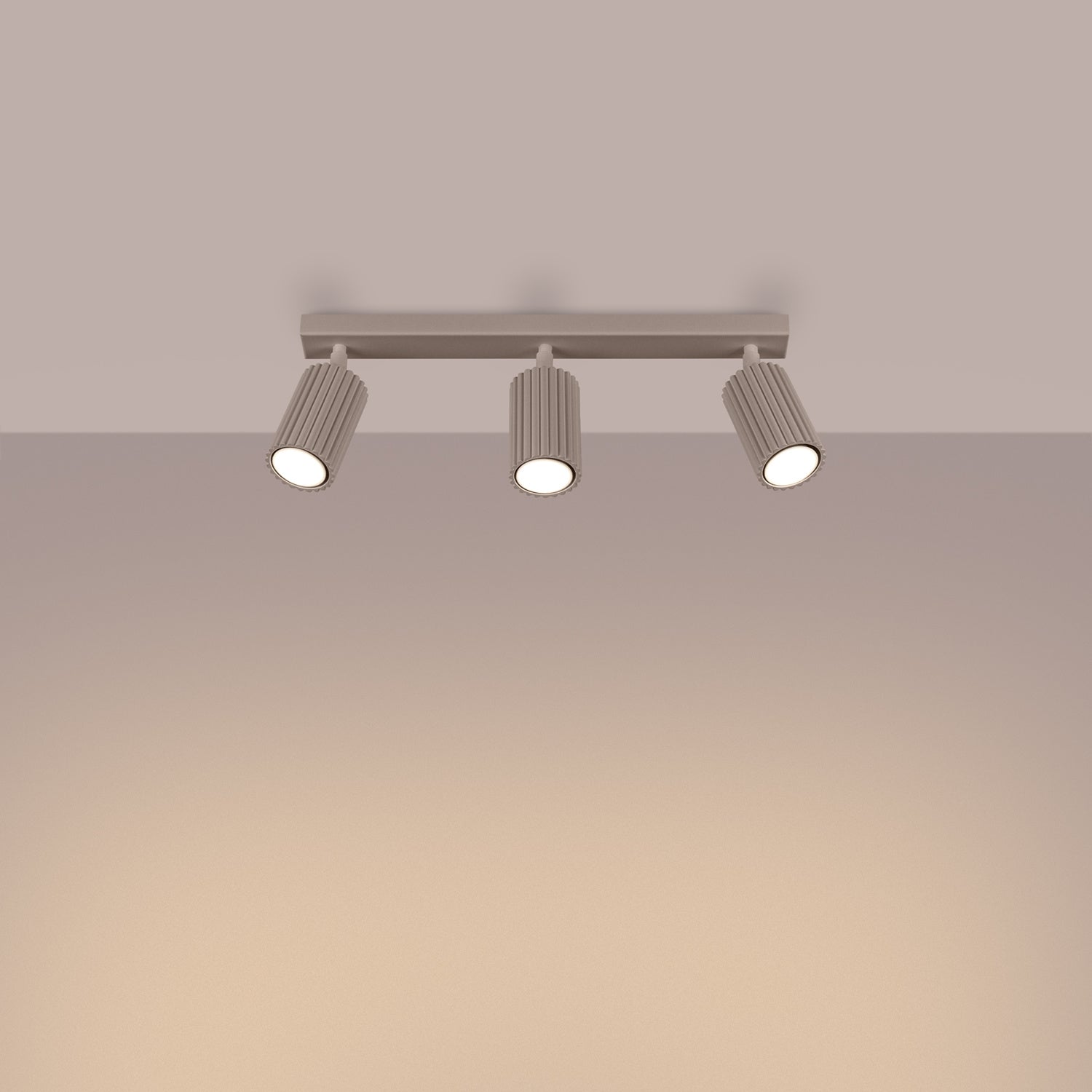 Taupe Triple Ribbed Spotlight Bar switched on in modern UK home interior, warm LED glow
