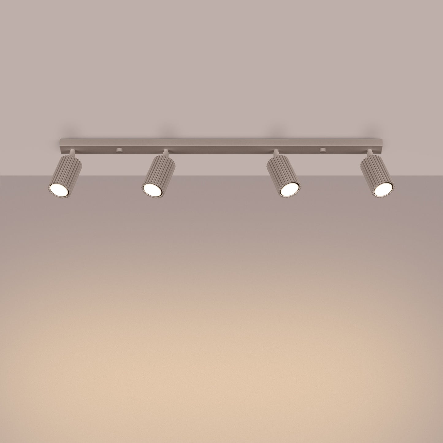 Taupe Four Light Ribbed Spotlight Bar switched on in modern UK home interior, warm LED glow