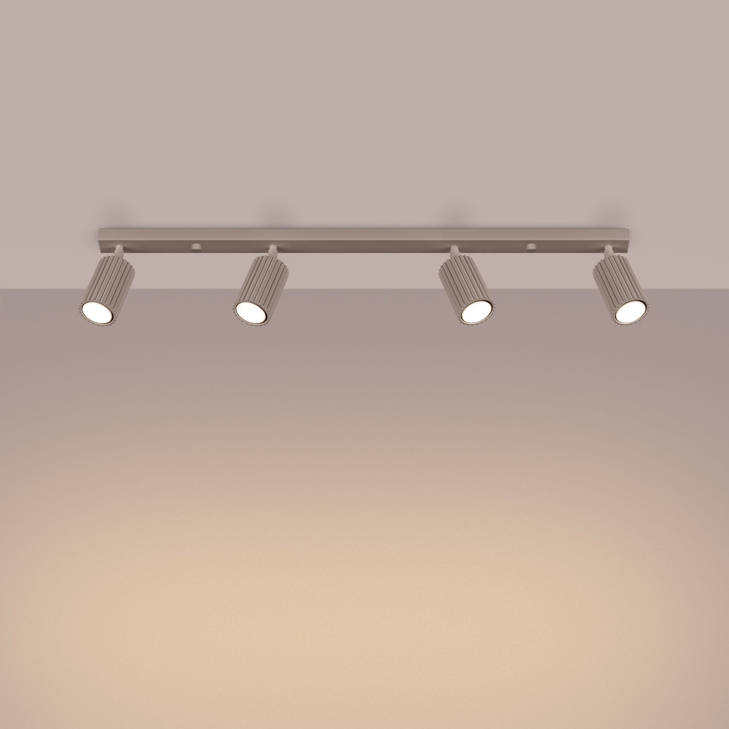 Taupe Four Light Ribbed Spotlight Bar switched on in modern UK home interior, warm LED glow