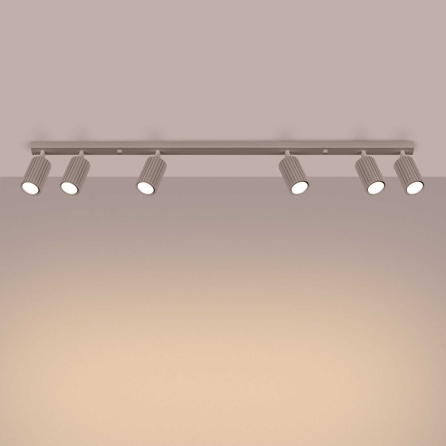 Taupe Six Light Ribbed Spotlight Bar switched on in modern UK home interior, warm LED glow