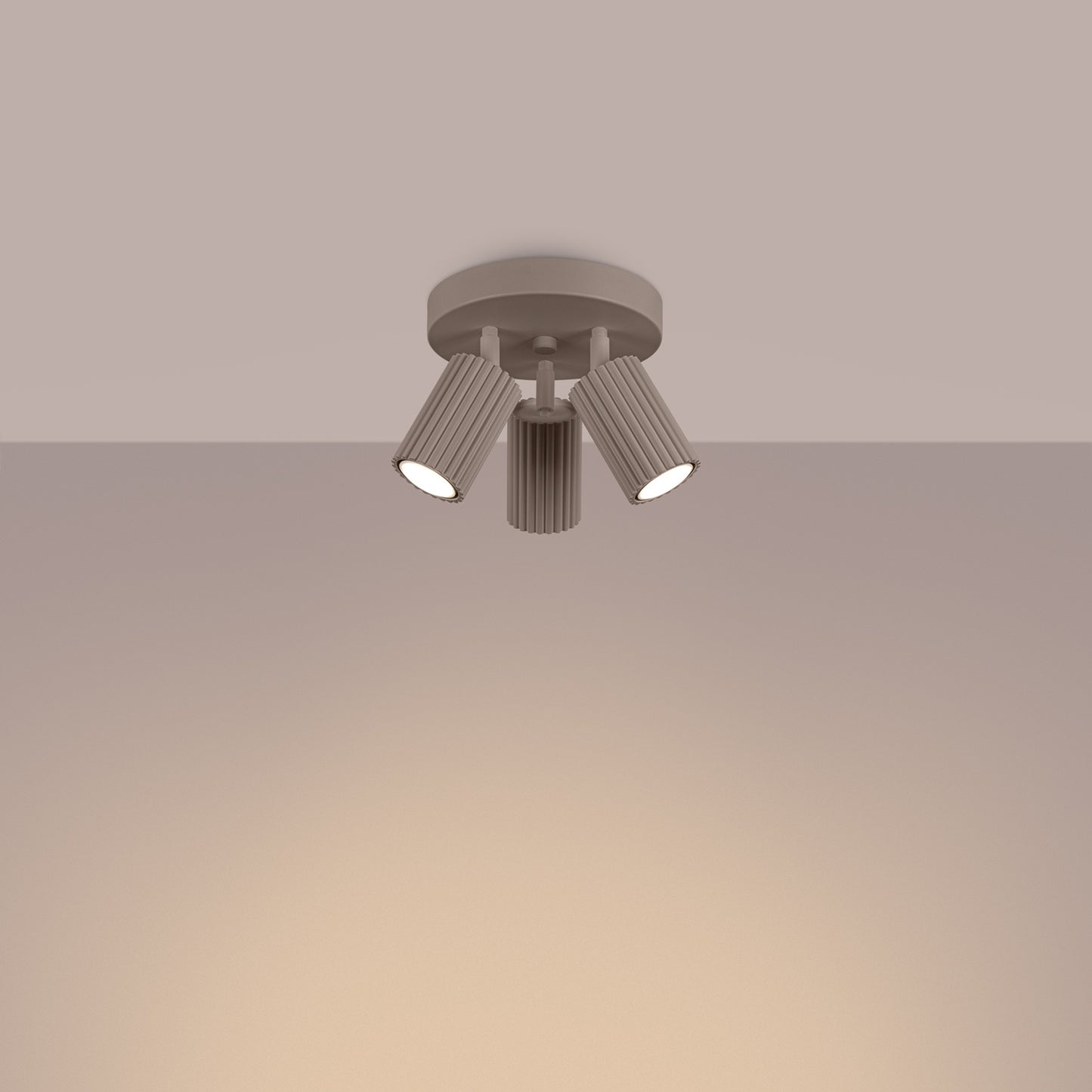 Taupe Triple Ribbed Spotlight Cluster switched on in modern UK home interior, warm LED glow