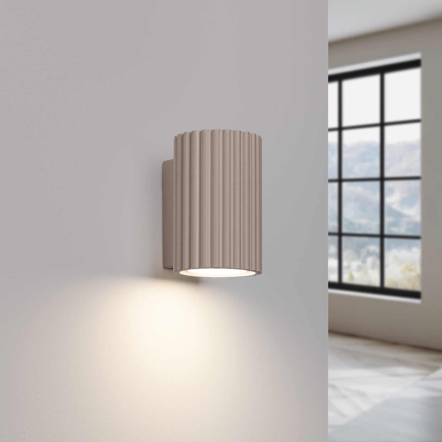 Taupe Mini Ribbed Cylinder Wall Light switched on in modern UK home interior, warm LED glow