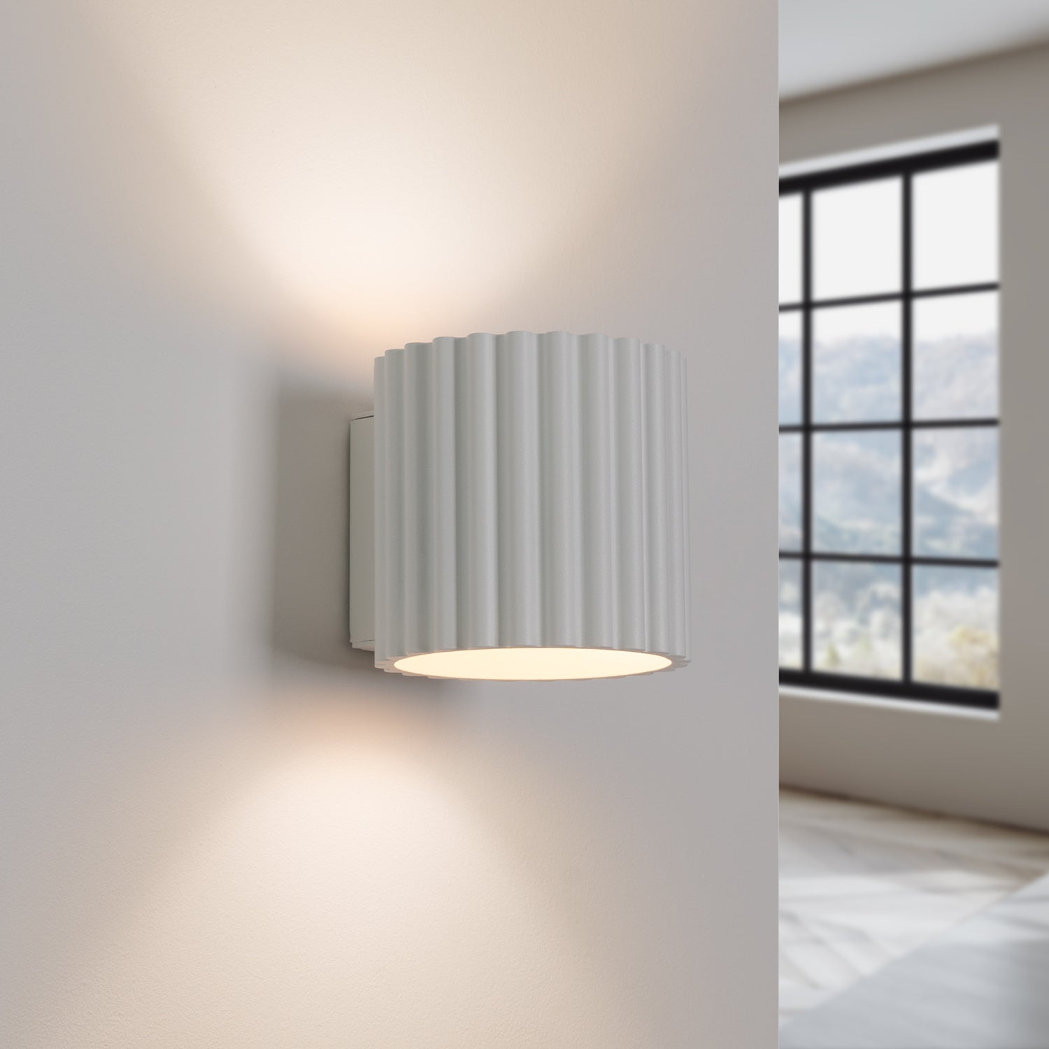 White Square Up Down Wall Light switched on in modern UK home interior, warm LED glow