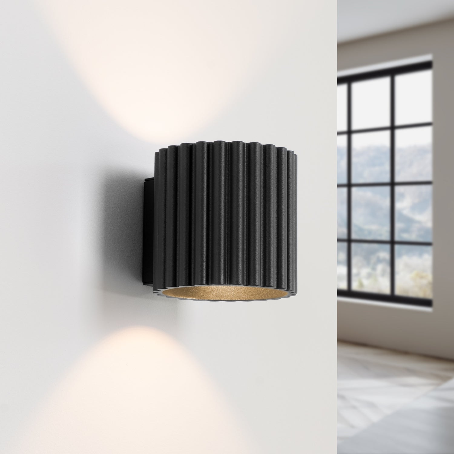 Black Square Up Down Wall Light switched on in modern UK home interior, warm LED glow