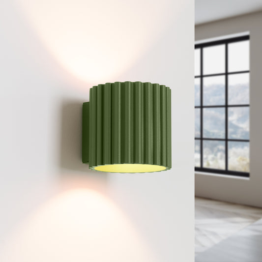 Olive Green Square Up Down Wall Light switched on in modern UK home interior, warm LED glow