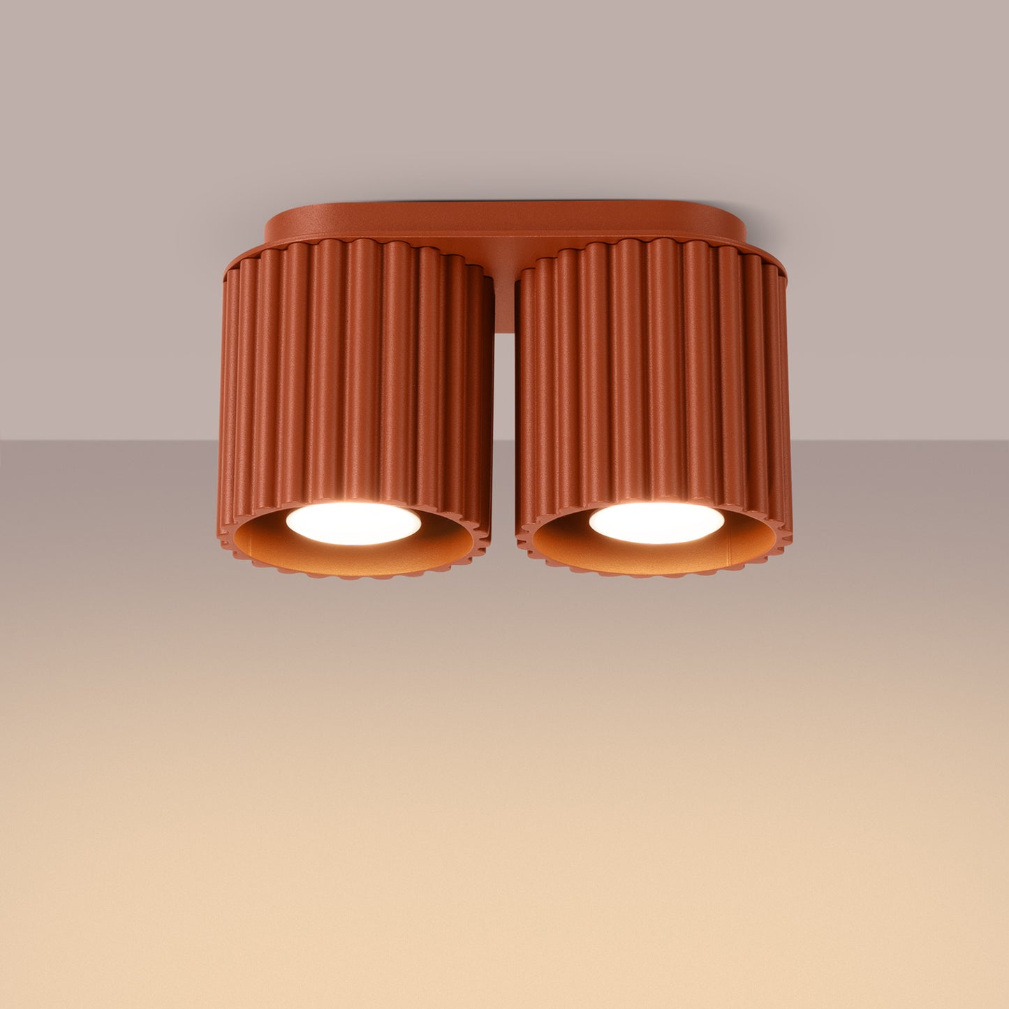 Red Ochre Twin Cube Surface Spotlight Bar switched on in modern UK home interior, warm LED glow
