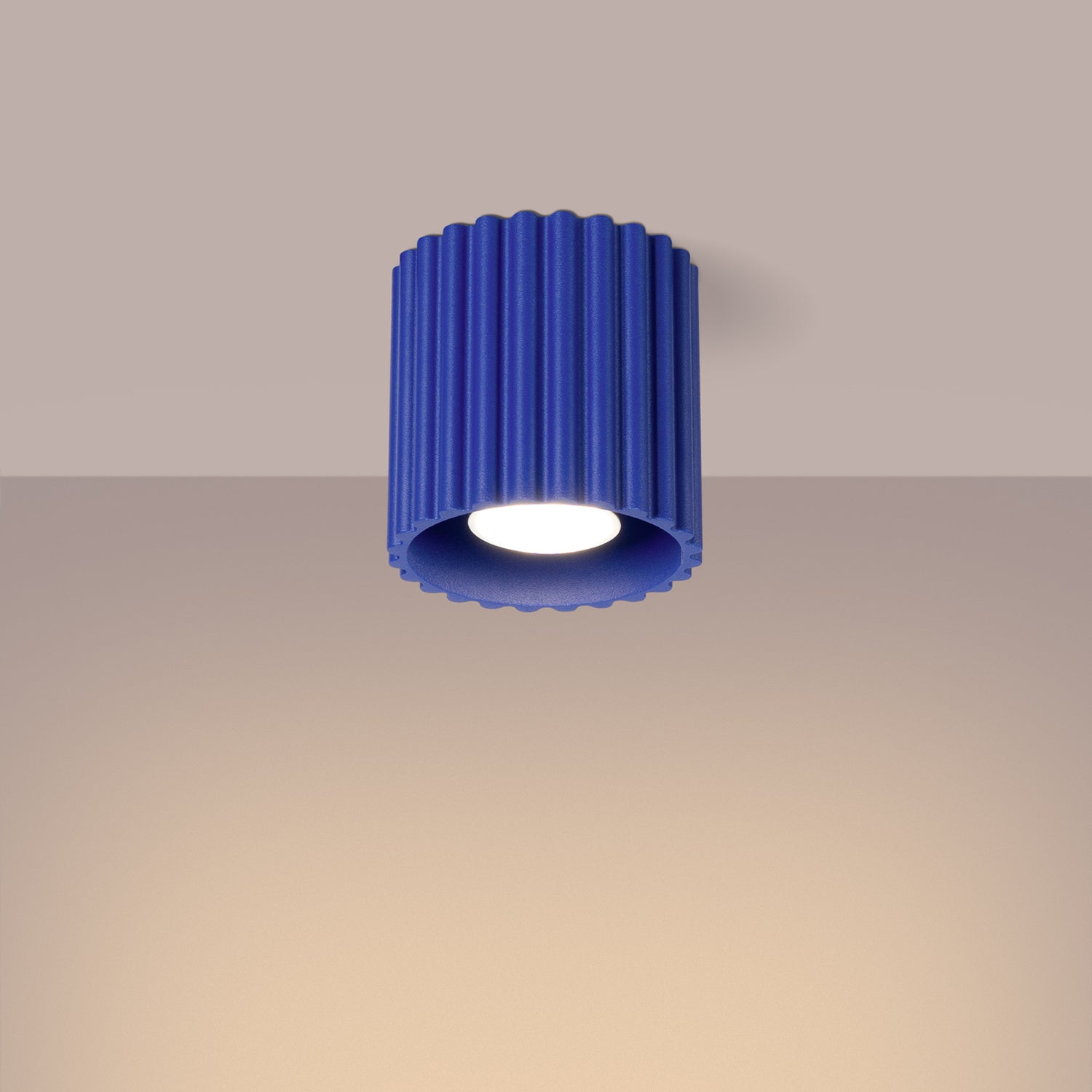 Ultramarine Square Cube Surface Spotlight switched on in modern UK home interior, warm LED glow