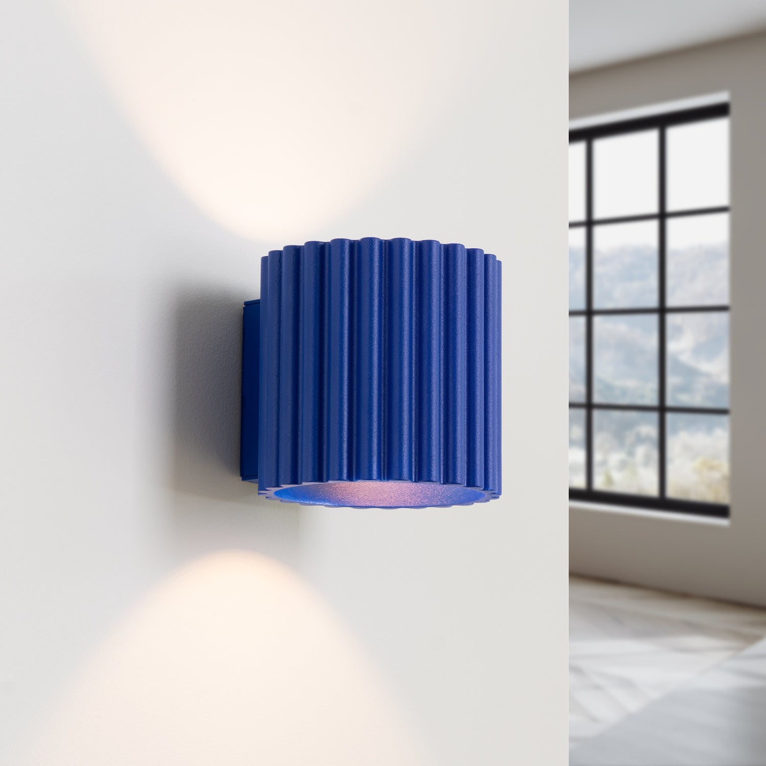 Ultramarine Square Up Down Wall Light switched on in modern UK home interior, warm LED glow