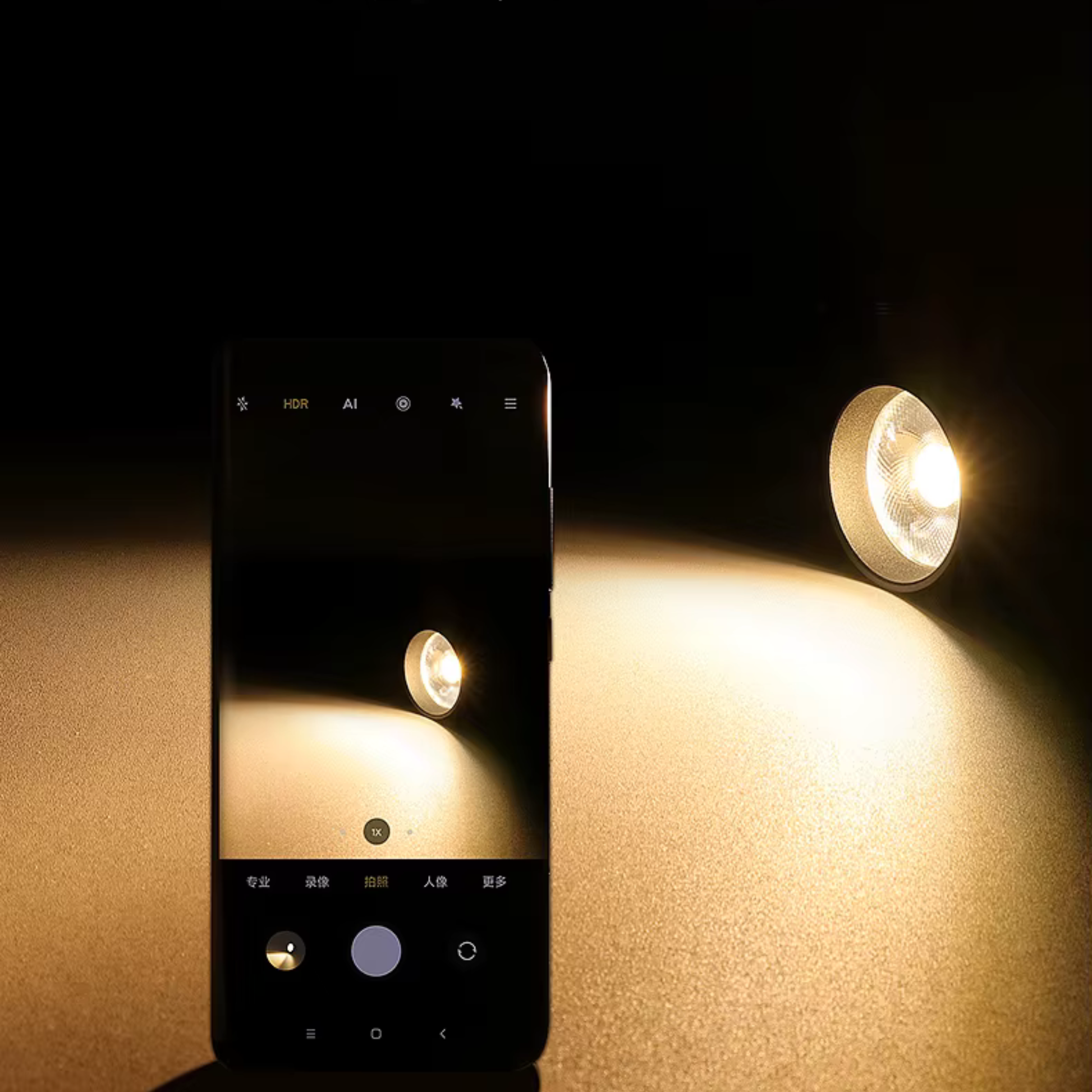 Smartphone taking a photo of a light bulb on a dark background