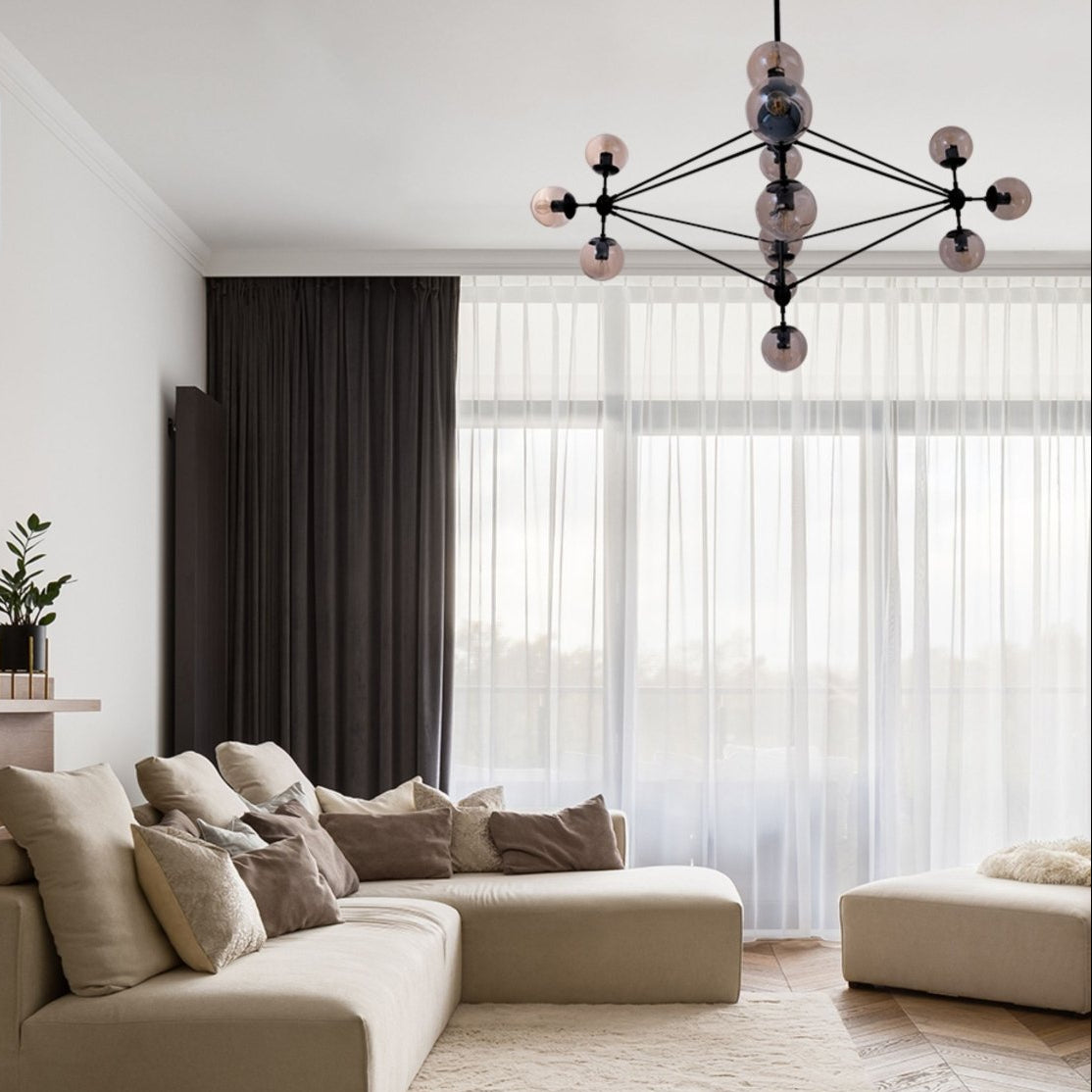 Black Rod 10 Amber Globe Molecule Chandelier installed in modern UK home interior with warm LED glow, contemporary lighting design