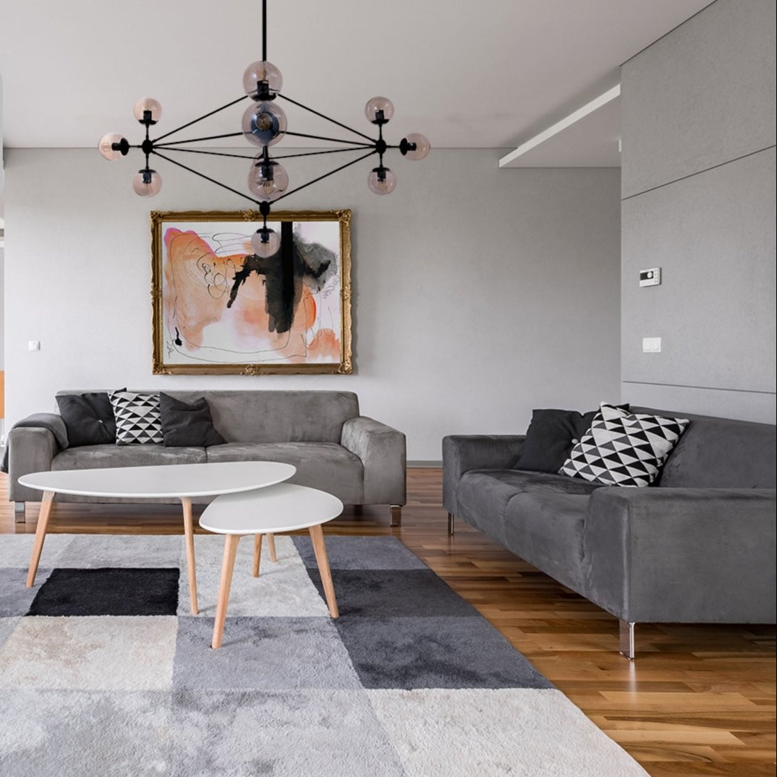 Black Rod 10 Amber Globe Molecule Chandelier installed in modern UK home interior with warm LED glow, contemporary lighting design